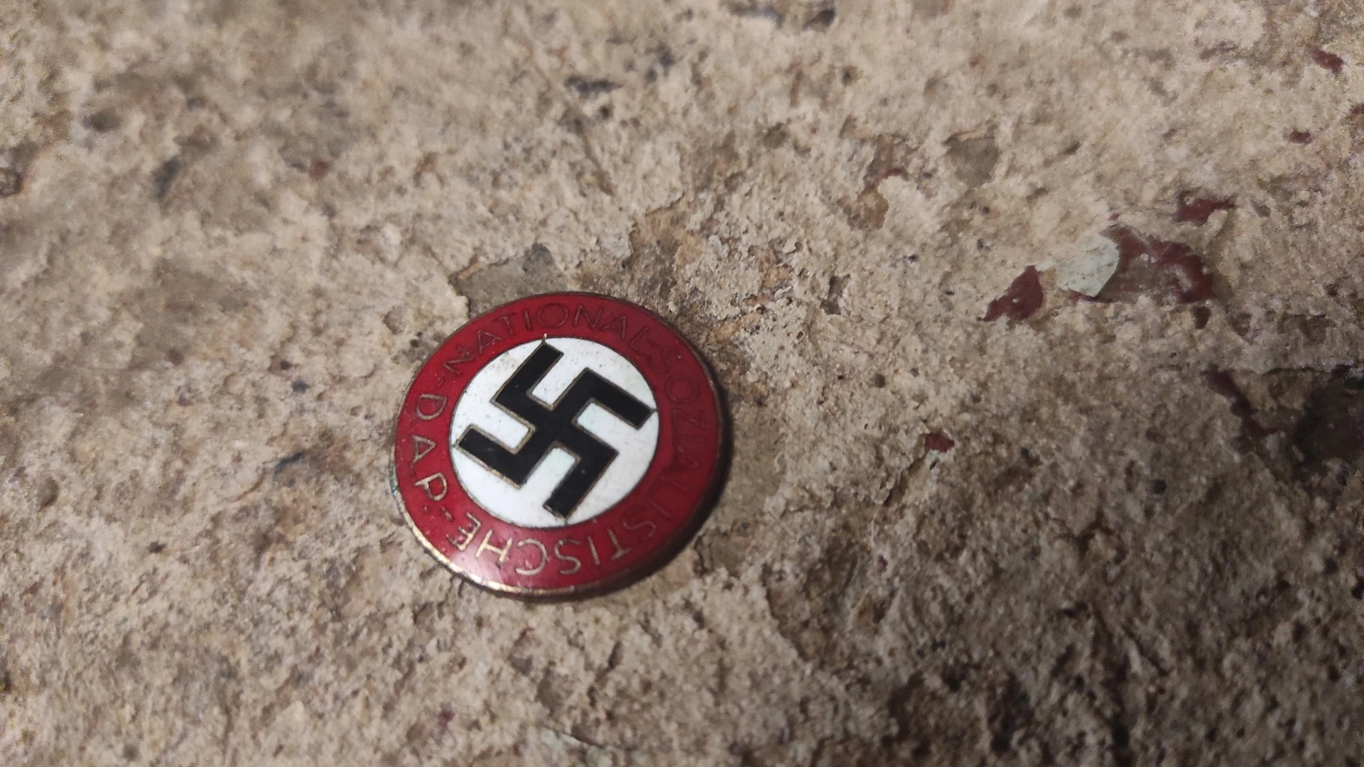 Odznak NSDAP nalezený v podzemí
